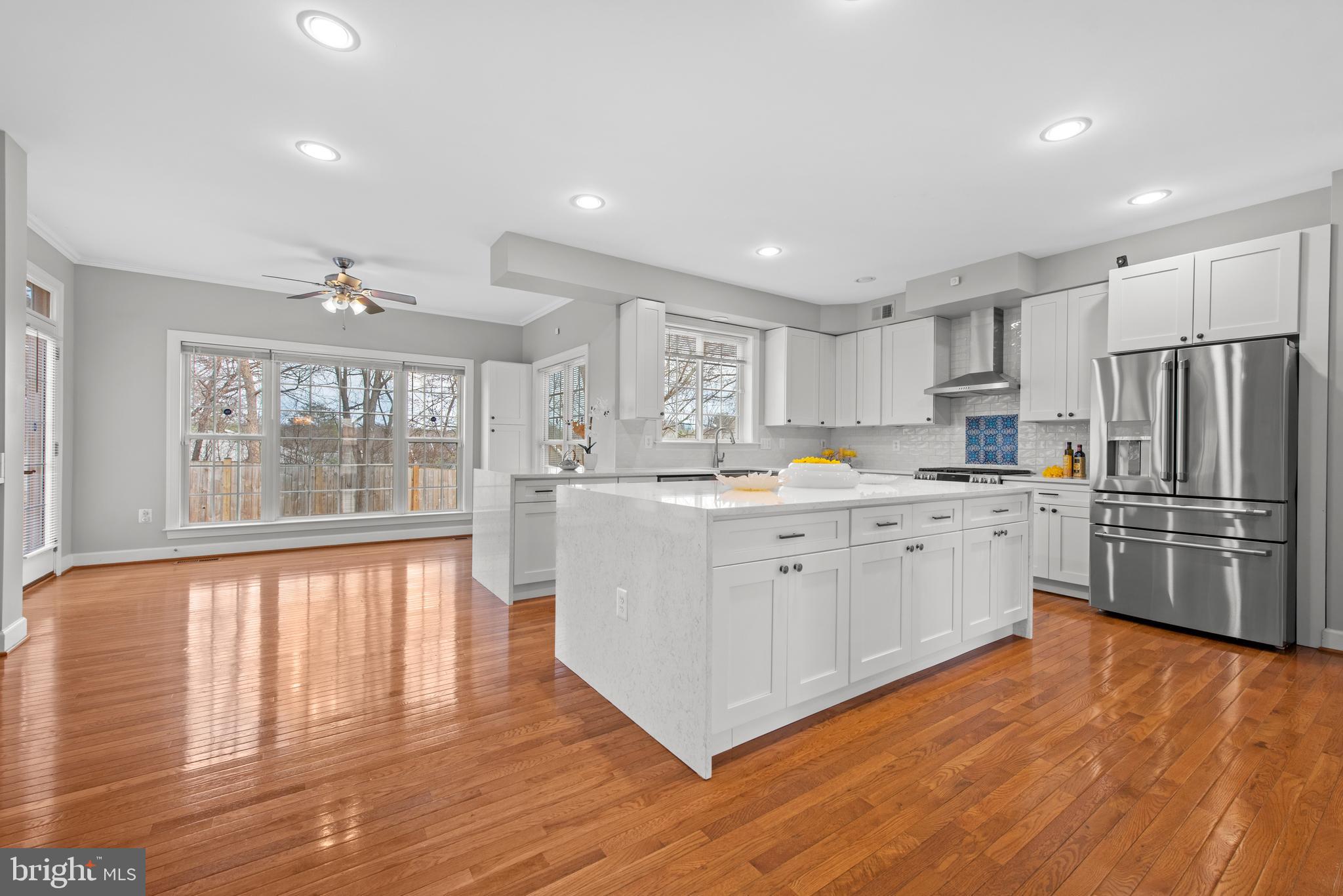 403 Madison Street Herndon, VA 20170 - Photo 14 of 63 a kitchen with stainless steel appliances granite countertop a refrigerator a sink dishwasher a stove and white countertops with wooden floor