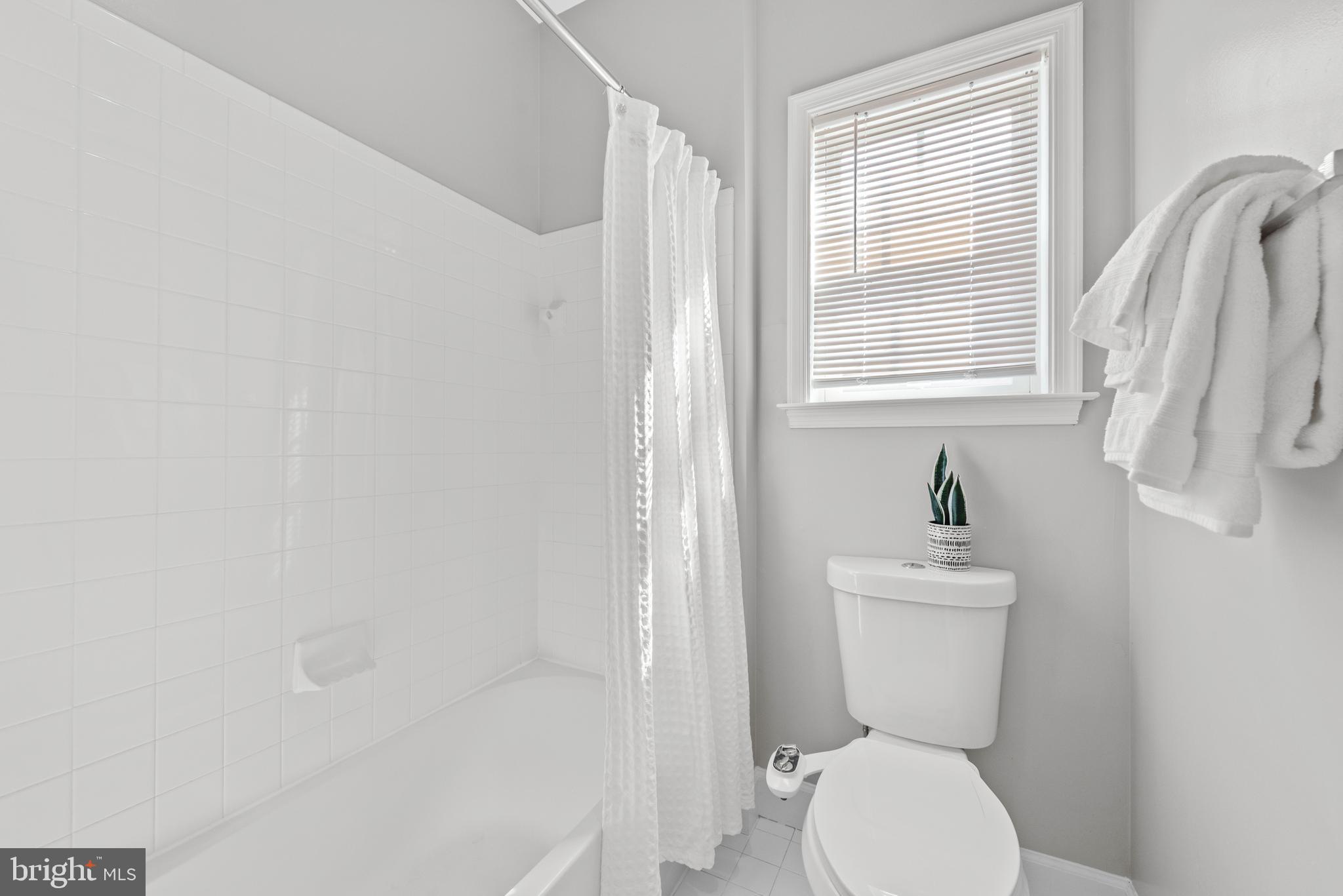 403 Madison Street Herndon, VA 20170 - Photo 46 of 63 a white toilet sitting next to a bathroom sink