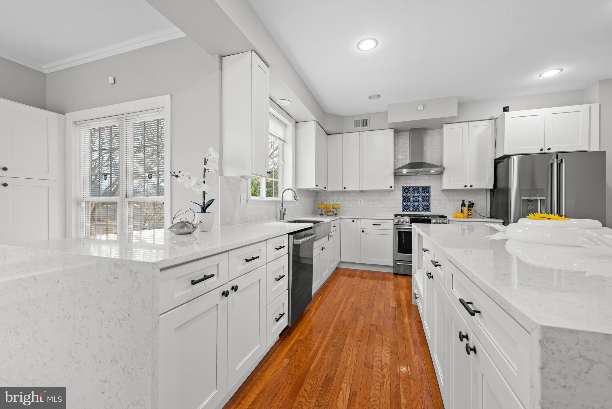 403 Madison Street Herndon, VA 20170 - Photo 10 of 63 a large kitchen with kitchen island a large counter top space a sink stainless steel appliances and cabinets