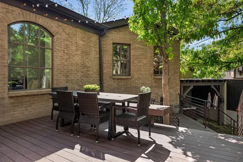 a view of a patio with table and chairs
