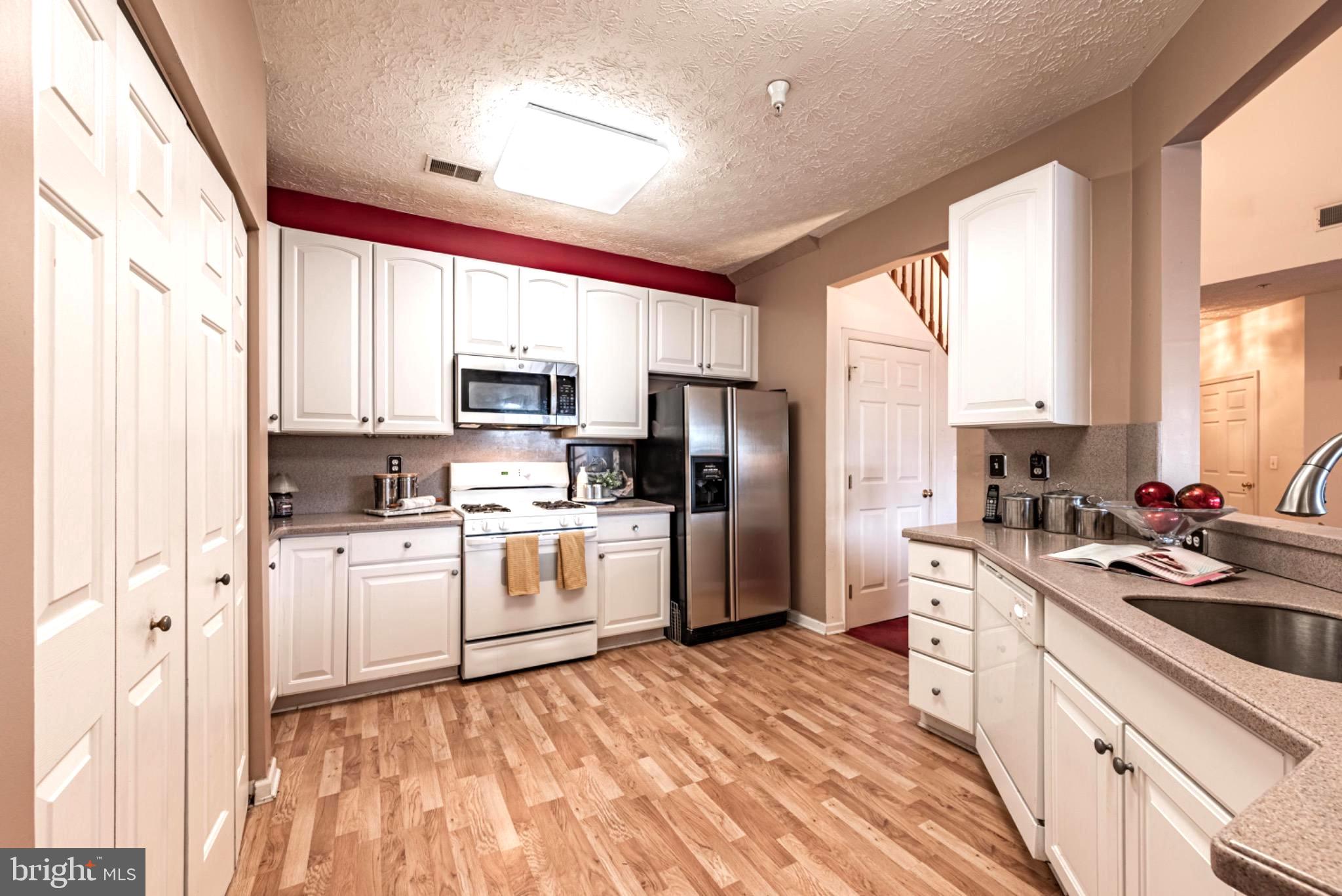 5032 Brightleaf Court, Unit 5032 Rosedale, MD 21237 - Photo 11 of 18 Modern kitchen with warm wood floors.