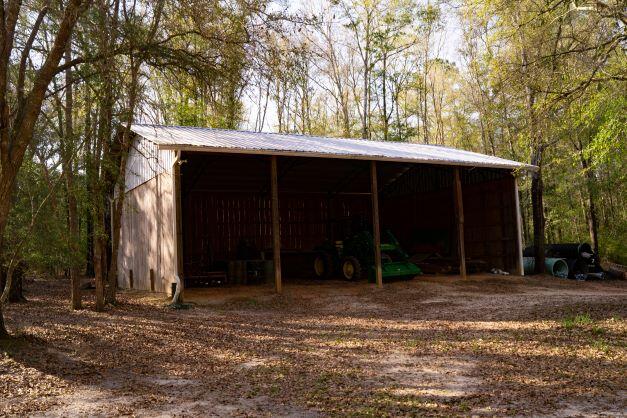 2199 Curtis Madden Road Baker, FL 32531 - Photo 17 of 63 a front view of a house with a yard