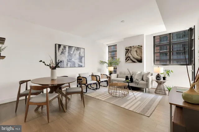 a living room with furniture a rug and a window