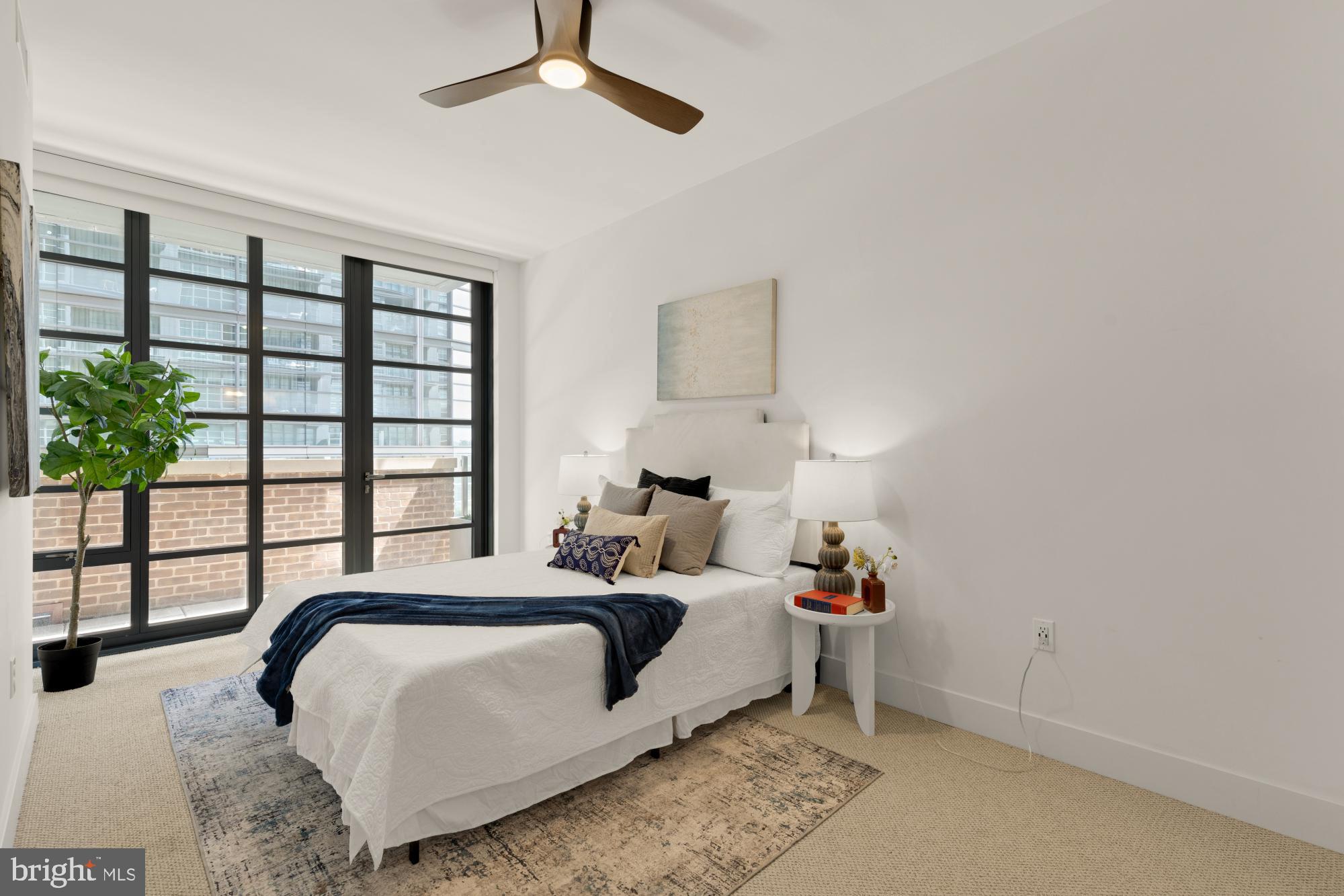 45 Sutton Square Southwest, Unit 303 Washington, DC 20024 - Photo 18 of 45 a spacious bedroom with a bed and a window