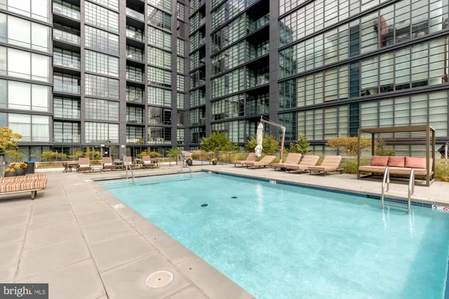 a swimming pool with outdoor seating and yard
