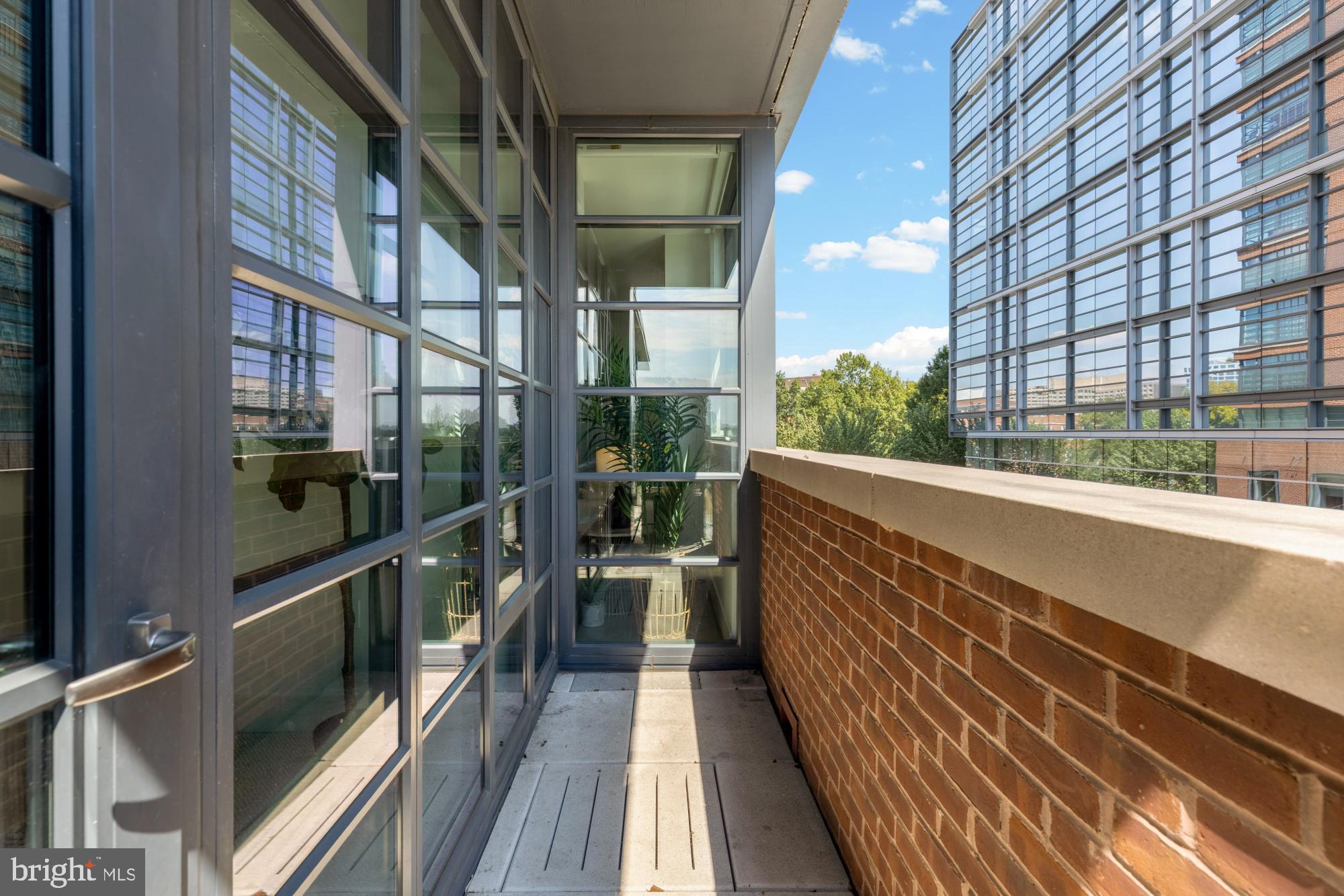 45 Sutton Square Southwest, Unit 303 Washington, DC 20024 - Photo 22 of 45 a view of balcony with wooden floor and brick walls