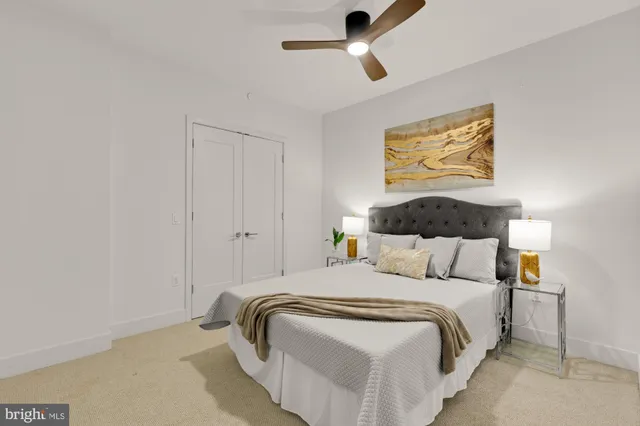 a bedroom with bed and painting on the wall