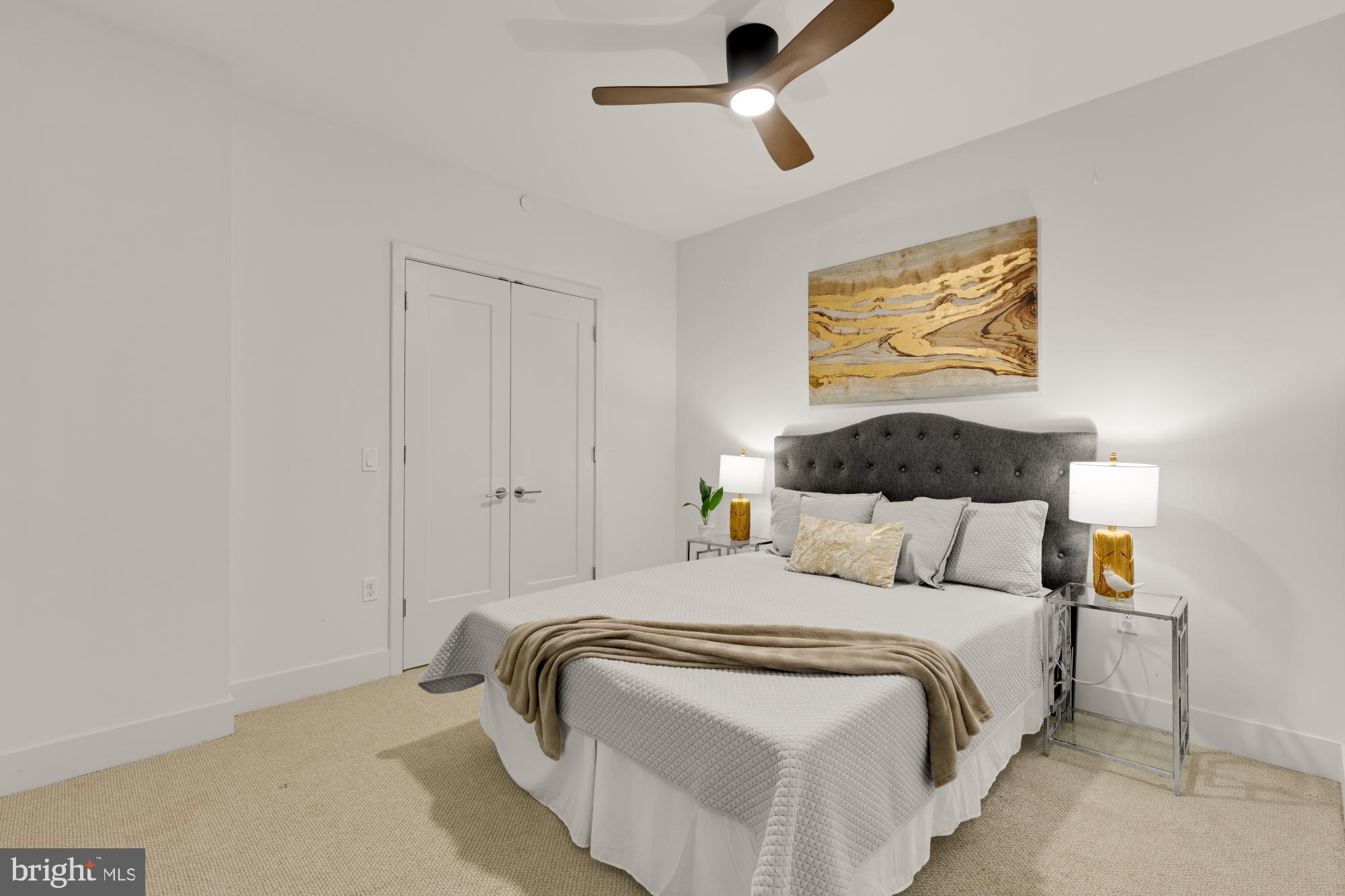 45 Sutton Square Southwest, Unit 303 Washington, DC 20024 - Photo 28 of 45 a bedroom with bed and painting on the wall