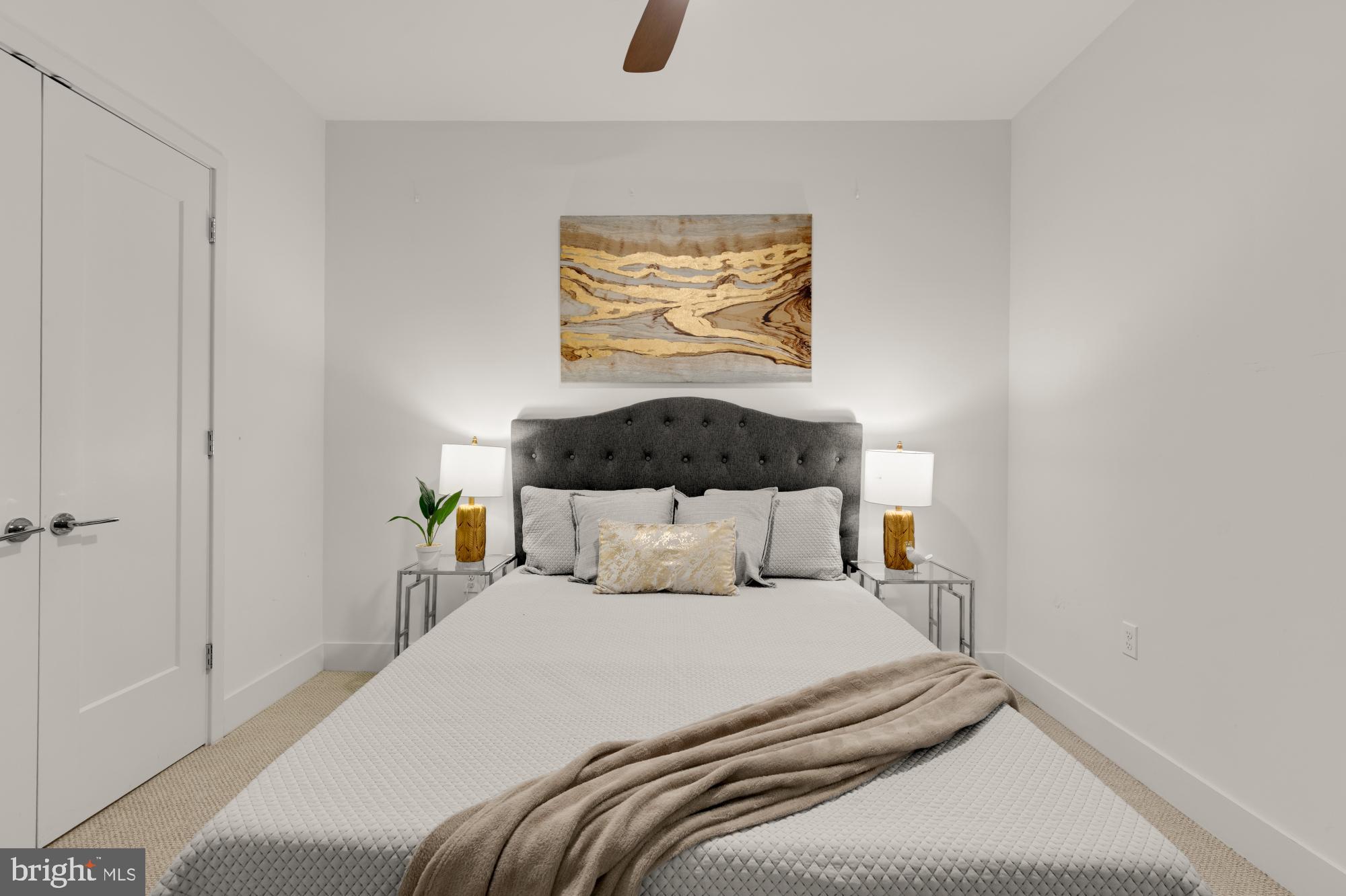 45 Sutton Square Southwest, Unit 303 Washington, DC 20024 - Photo 29 of 45 a bedroom with a bed and painting on the wall