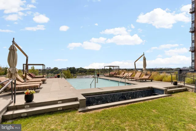 a view of a swimming pool with seating area