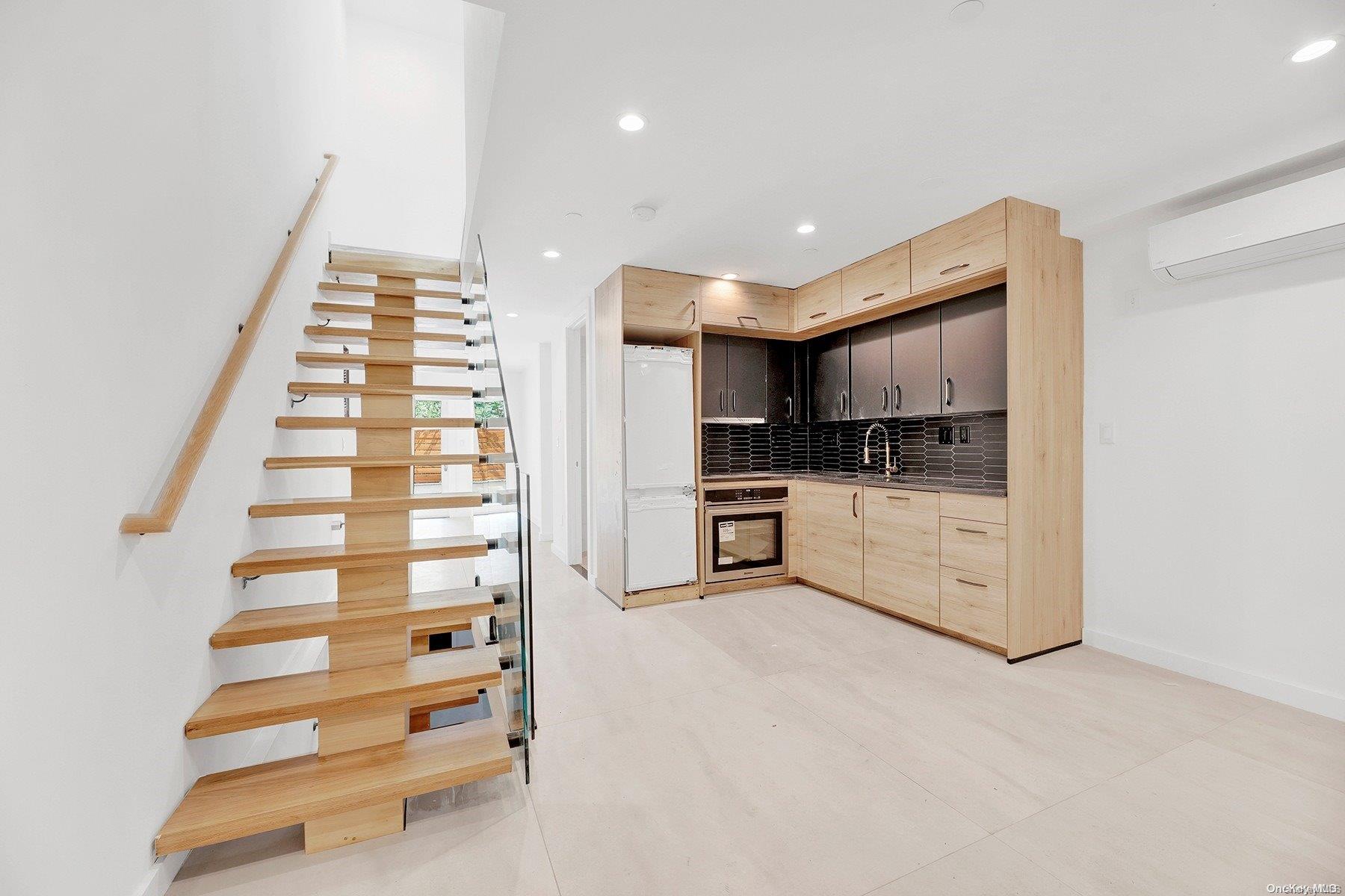 1511 Pacific Street Brooklyn, NY 11213 - Photo 16 of 31 a kitchen with stainless steel appliances and white cabinets