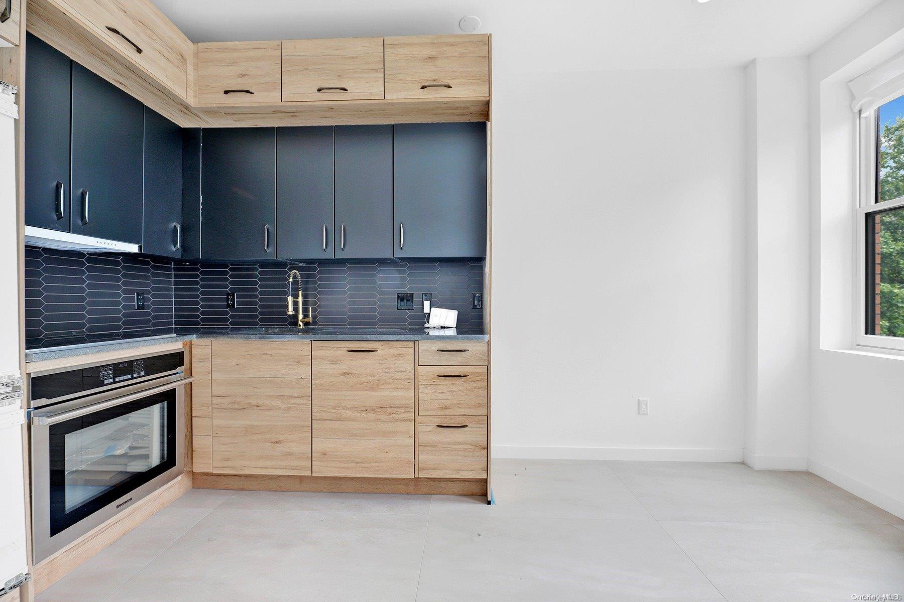 1511 Pacific Street Brooklyn, NY 11213 - Photo 18 of 31 a kitchen with stainless steel appliances granite countertop a stove a sink and a microwave