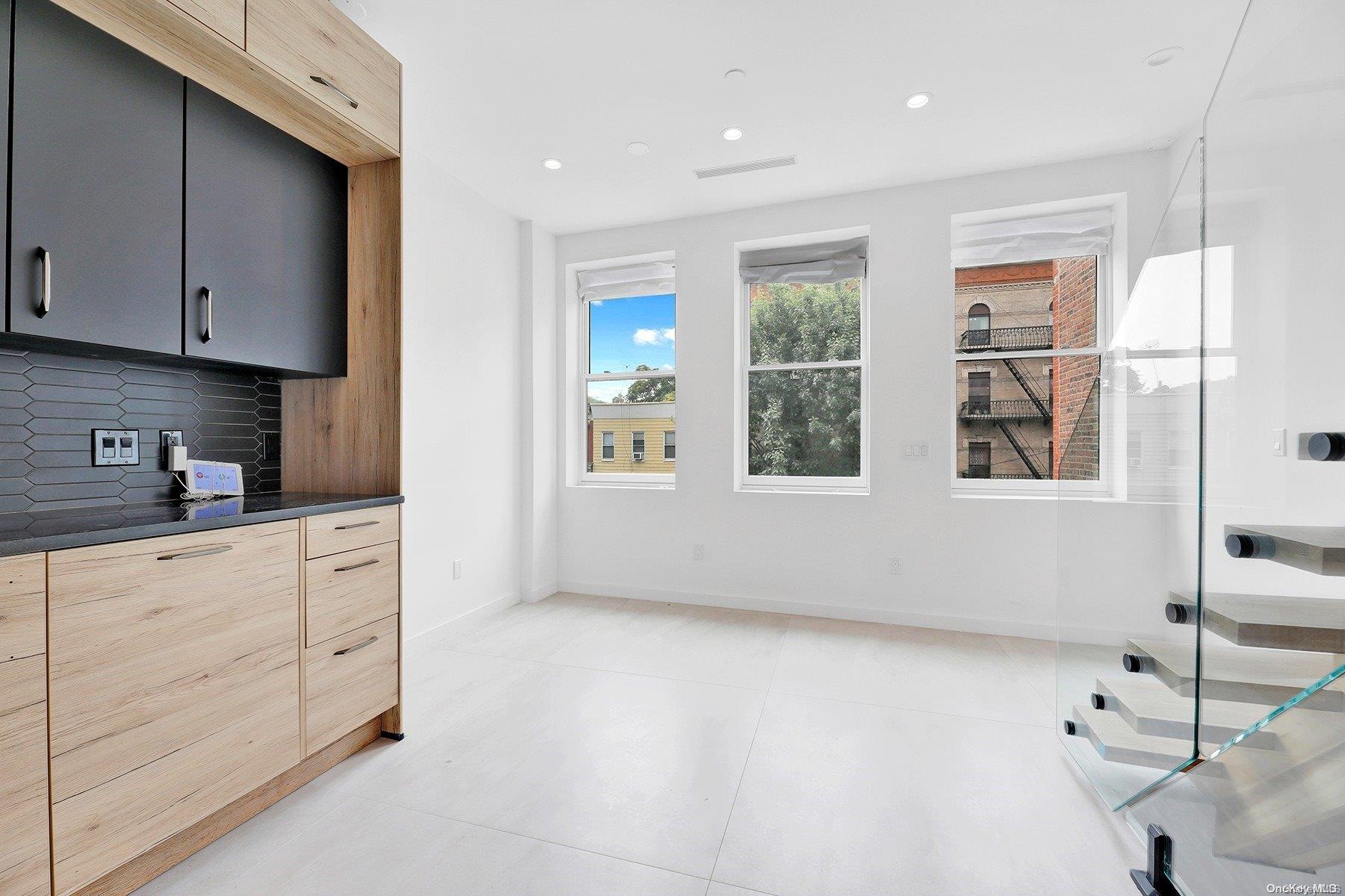 1511 Pacific Street Brooklyn, NY 11213 - Photo 20 of 31 a kitchen with stainless steel appliances granite countertop a stove a sink and white cabinets with wooden floor