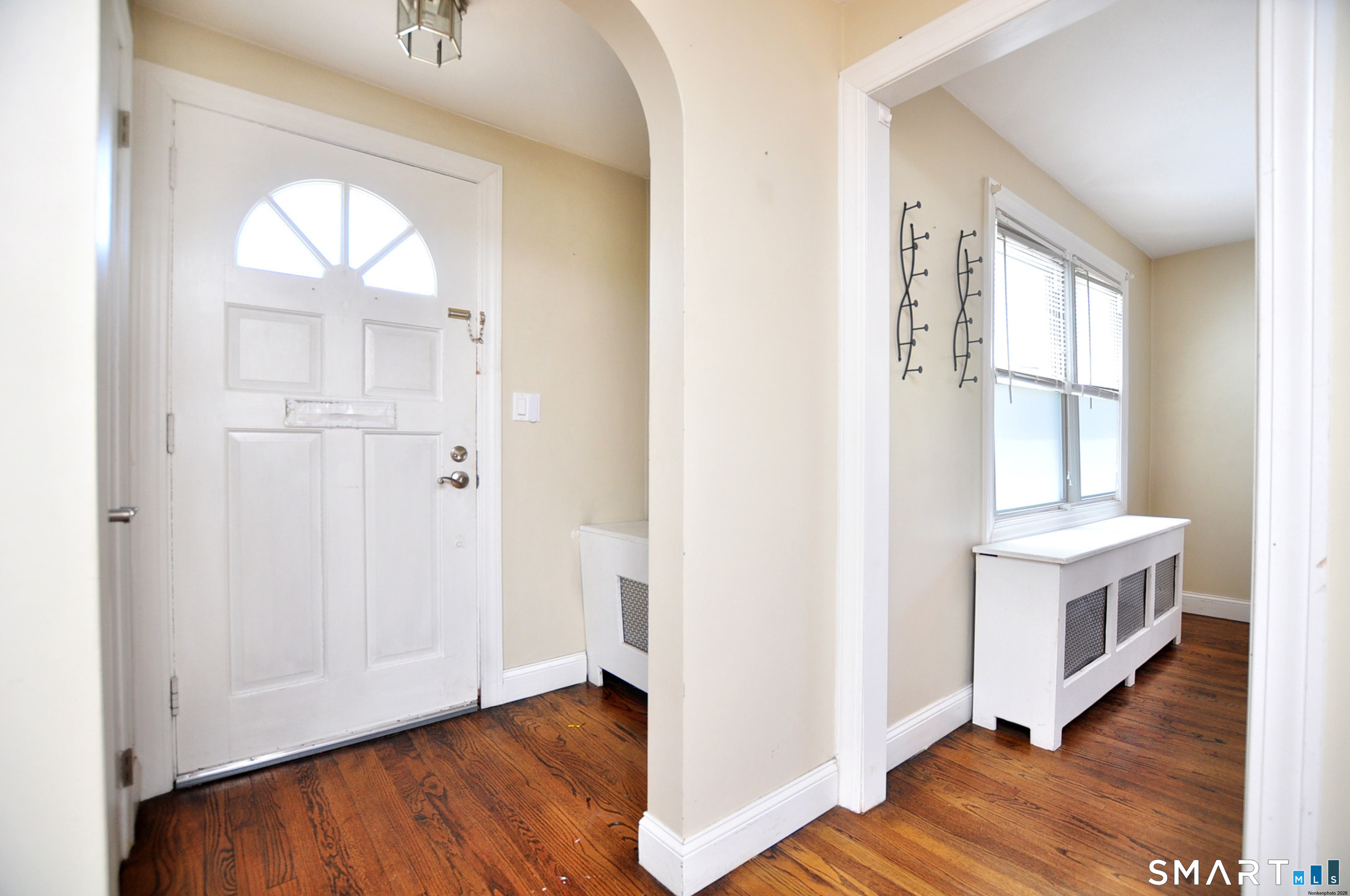 103 West Center Street Manchester, CT 06040 - Photo 6 of 29 an empty room with wooden floor and windows