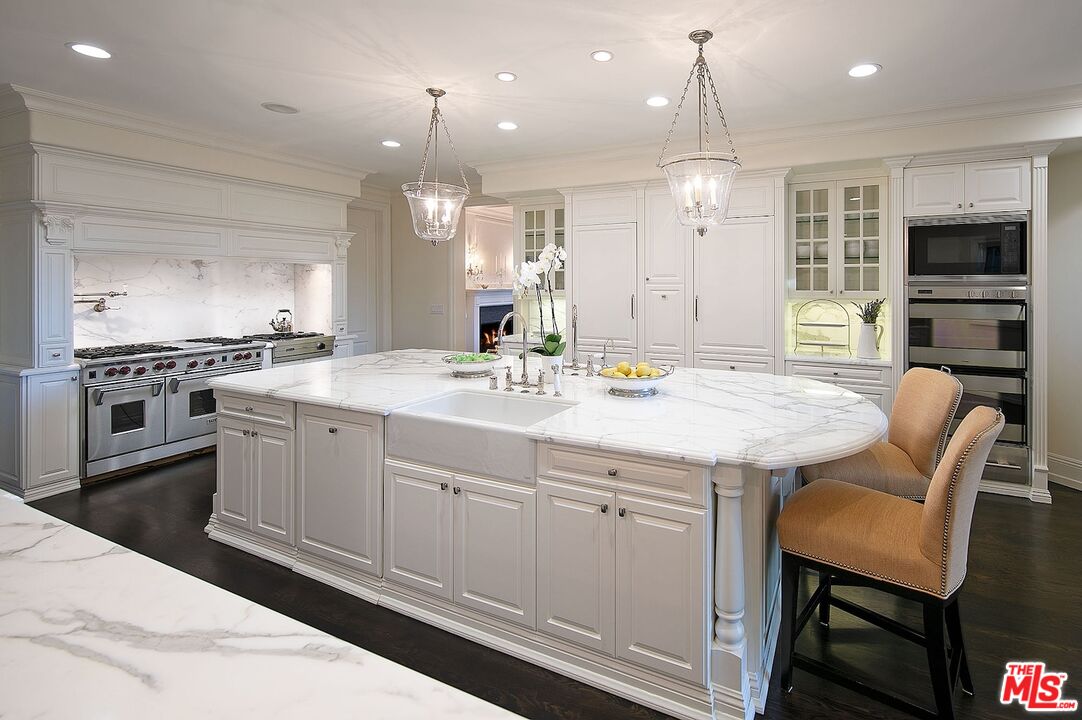 655 North Faring Road Los Angeles, CA 90077 - Photo 9 of 23 a kitchen with kitchen island granite countertop a sink and stainless steel appliances