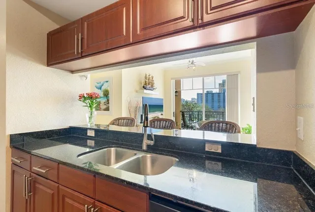 a kitchen with a sink and large window