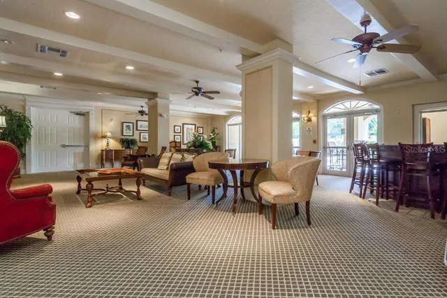 a living room with furniture a dining table and chairs with wooden floor