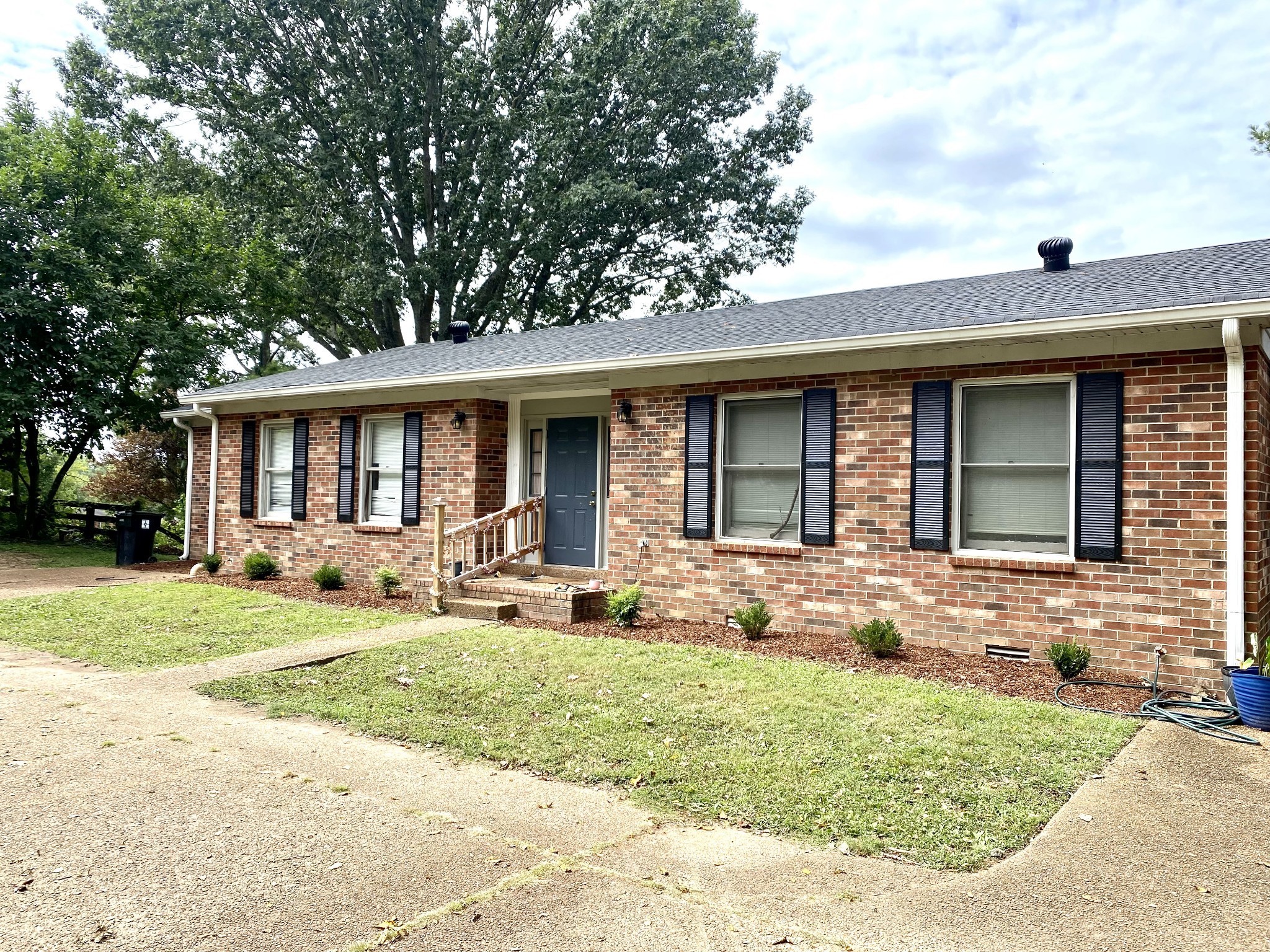 a front view of a house with garden and porch
