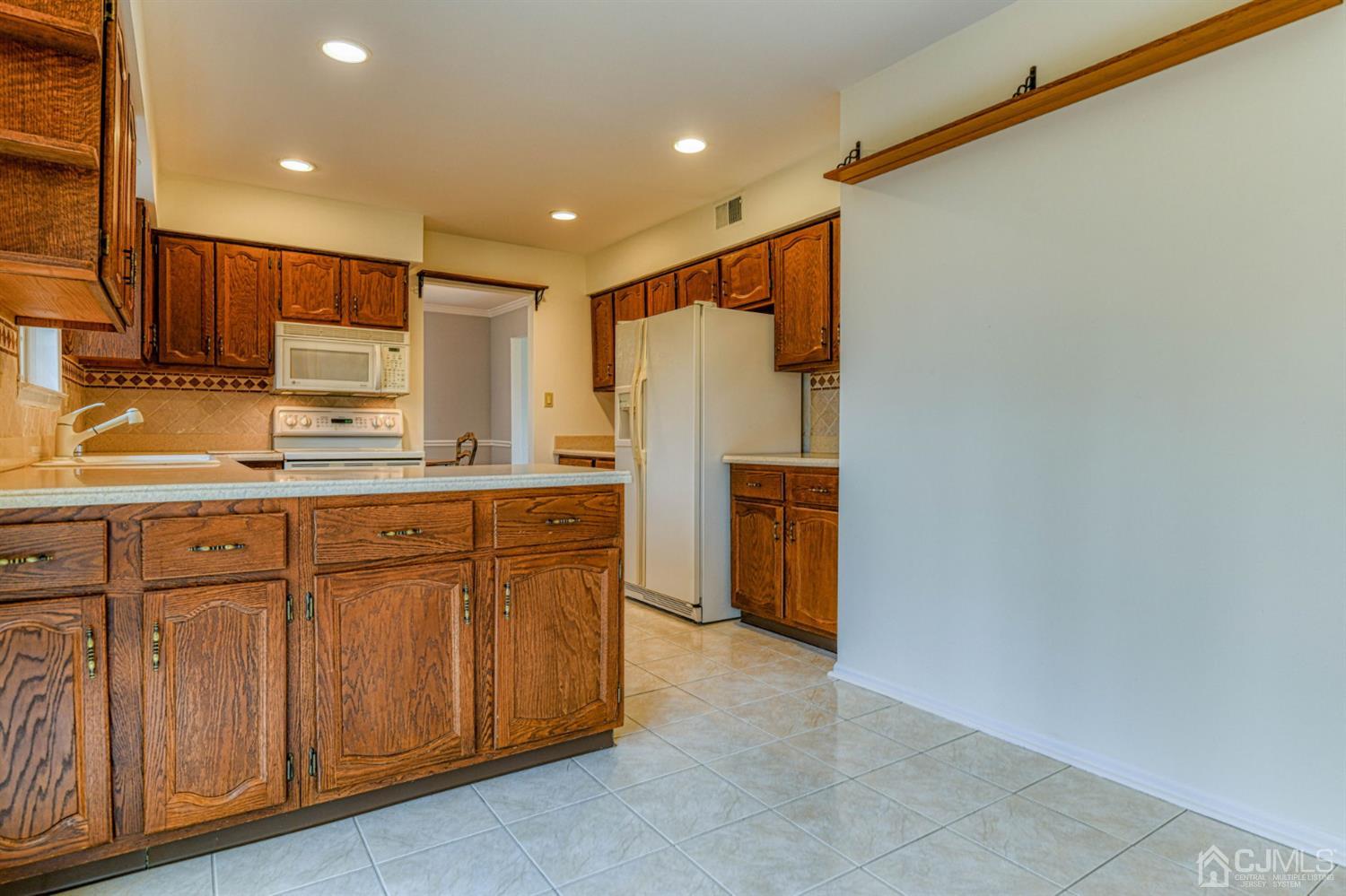 43 Pinecrest Road Somerset, NJ 08873 - Photo 12 of 34 a kitchen with stainless steel appliances granite countertop a refrigerator and a sink