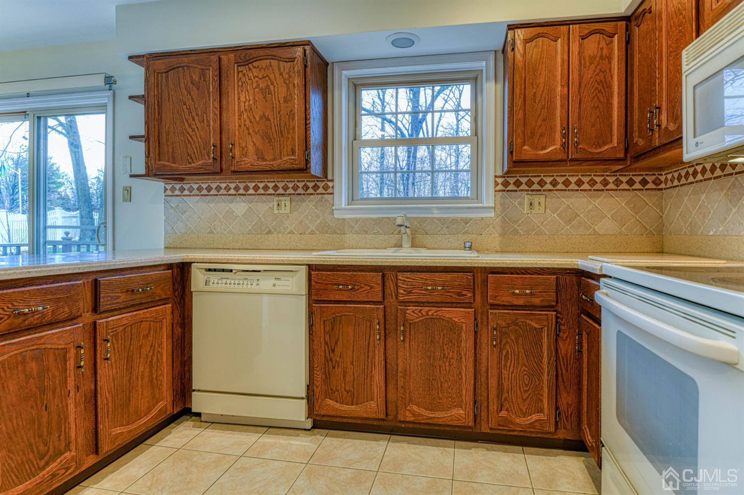 43 Pinecrest Road Somerset, NJ 08873 - Photo 14 of 34 a kitchen with stainless steel appliances granite countertop a sink and cabinets