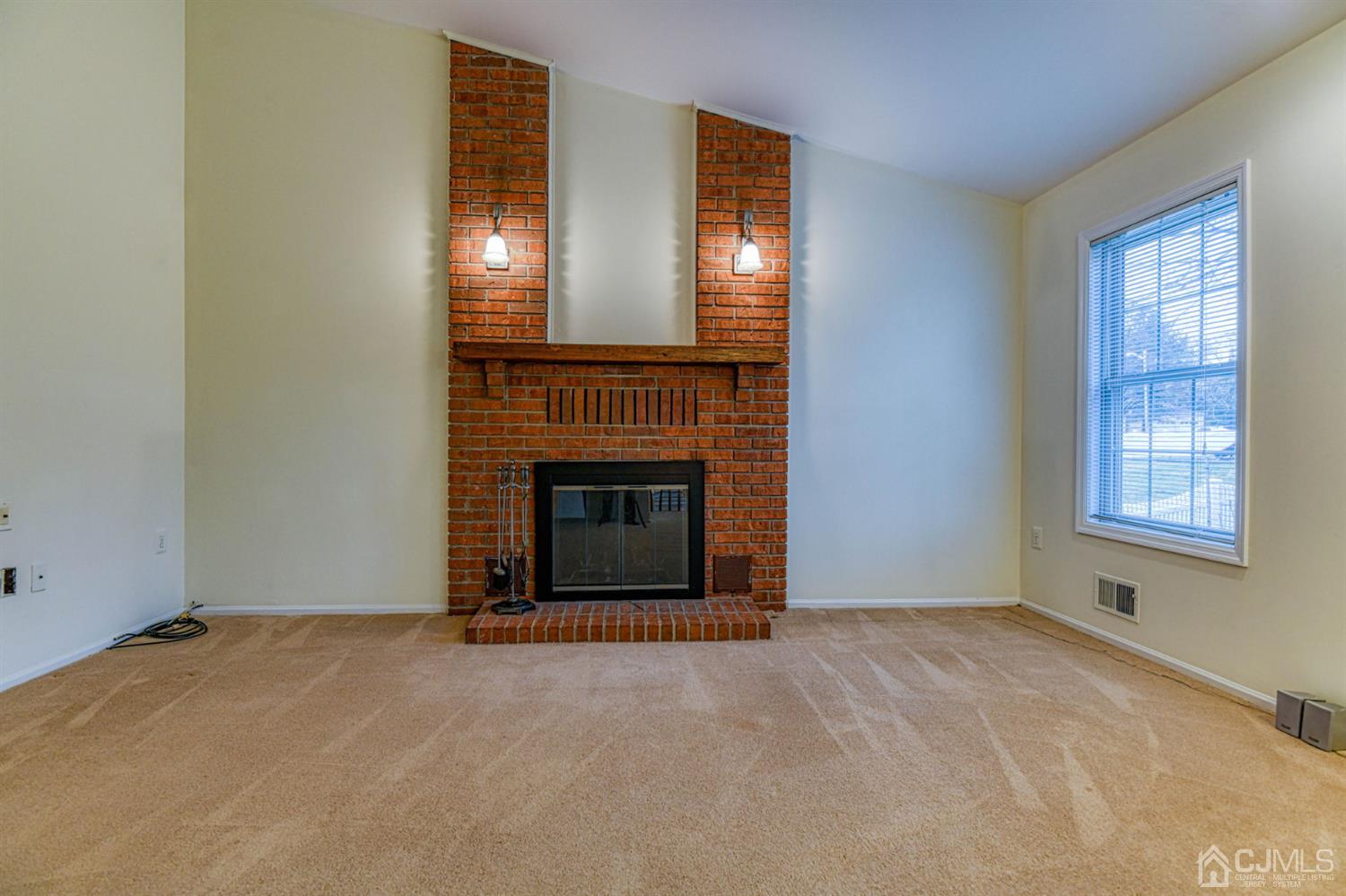 43 Pinecrest Road Somerset, NJ 08873 - Photo 18 of 34 a view of an empty room with chandelier and fireplace