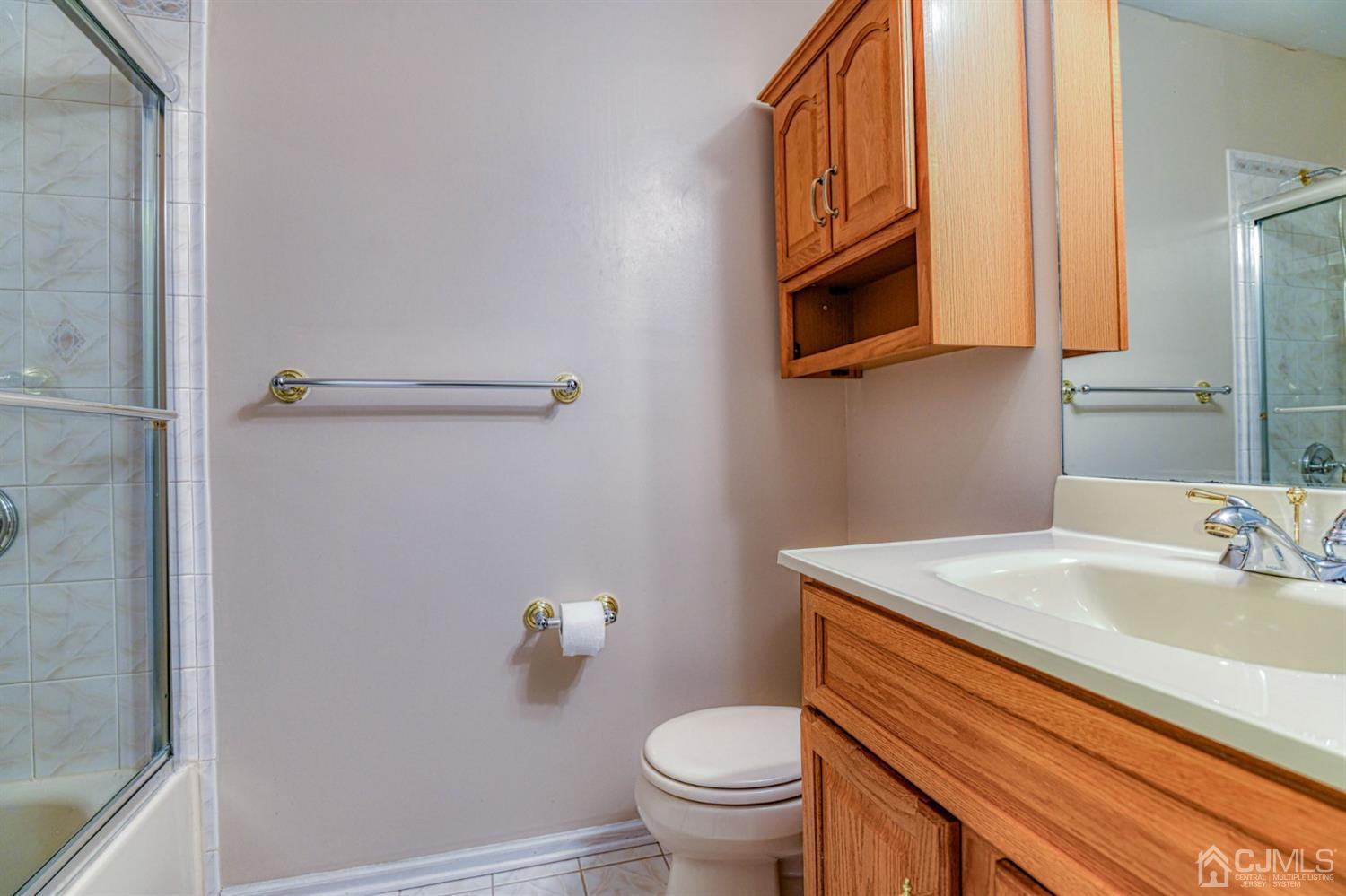 43 Pinecrest Road Somerset, NJ 08873 - Photo 29 of 34 a bathroom with a sink a toilet and mirror