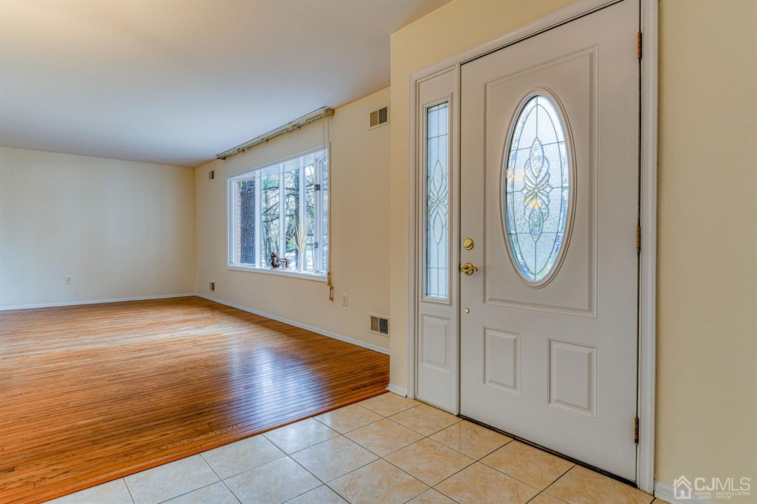 43 Pinecrest Road Somerset, NJ 08873 - Photo 4 of 34 a view of a livingroom with wooden floor and window