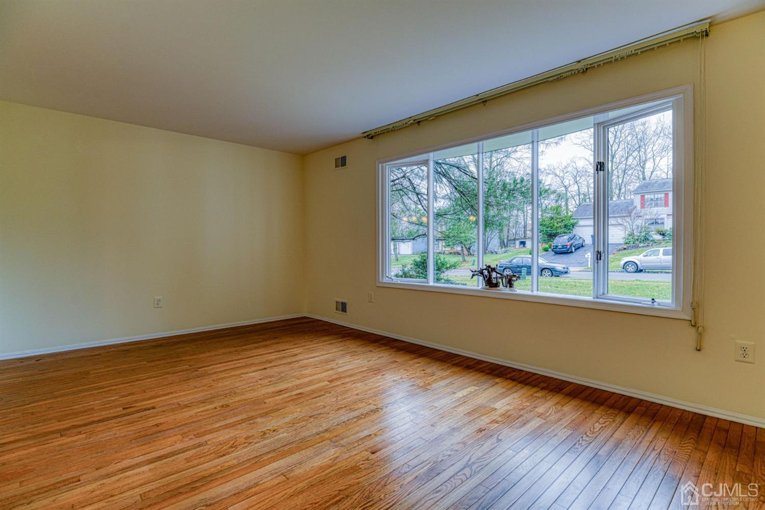 43 Pinecrest Road Somerset, NJ 08873 - Photo 5 of 34 a view of an empty room with wooden floor and a window