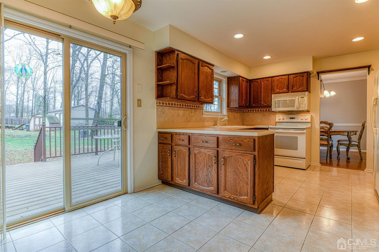 43 Pinecrest Road Somerset, NJ 08873 - Photo 10 of 34 a kitchen with stainless steel appliances granite countertop a stove a sink and a refrigerator