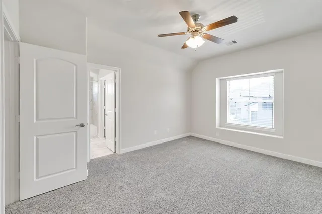 an empty room with closet and windows