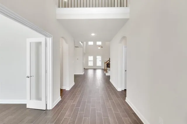 a view of a hallway with wooden floor