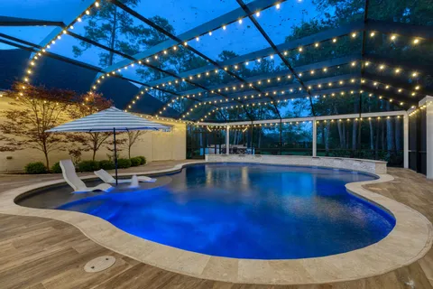 a bedroom with a large bed a potted plant and a large window