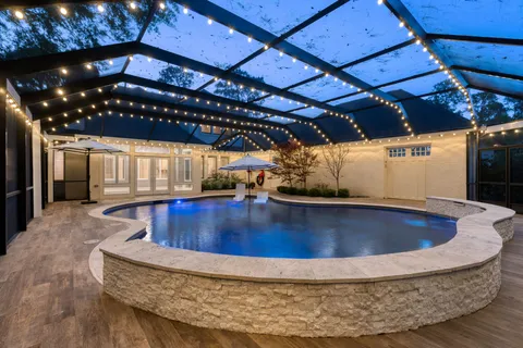 a bathroom with a sink shower and a mirror