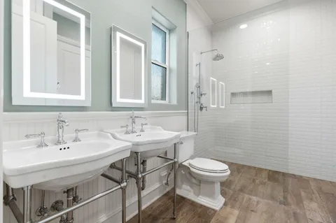 a living room with furniture a flat screen tv and a large window