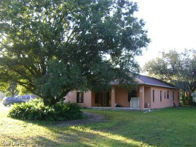 11630 Ruth Road North Fort Myers, FL 33917 - Photo 3 of 10 a front view of a house with a garden