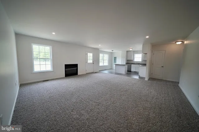 a view of a livingroom with a furniture and a fireplace