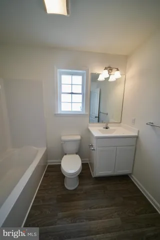 a bathroom with a sink toilet a bathtub and vanity