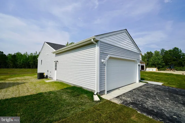 a backyard of a house with plants and garden