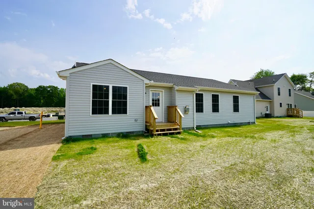 a backyard of a house with barbeque oven table and chairs