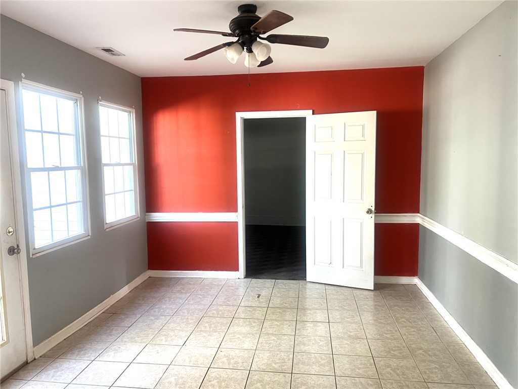 252 Friendship Road Seneca, SC 29678 - Photo 9 of 11 Tiled flooring and classic chair rail molding define this versatile living space.