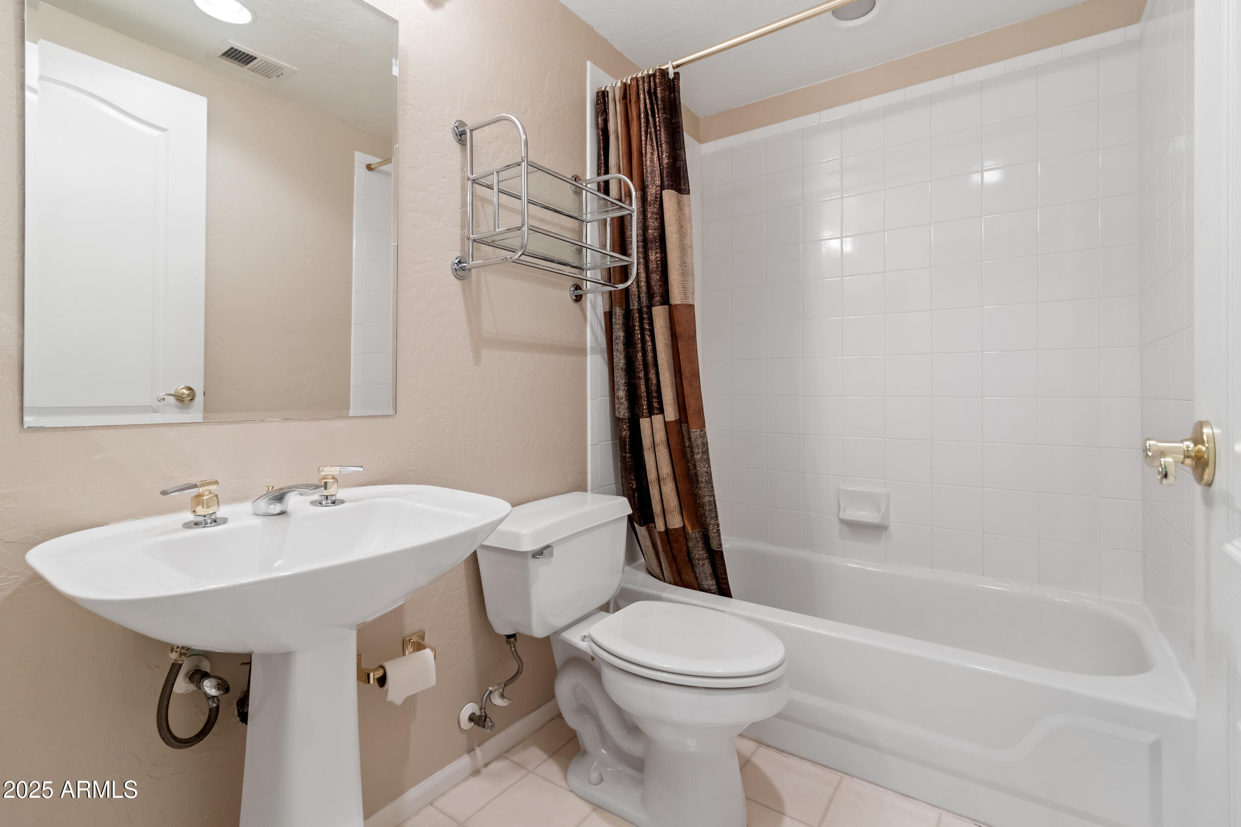 1747 East Northern Avenue, Unit 104 Phoenix, AZ 85020 - Photo 17 of 19 a bathroom with a sink a toilet and shower