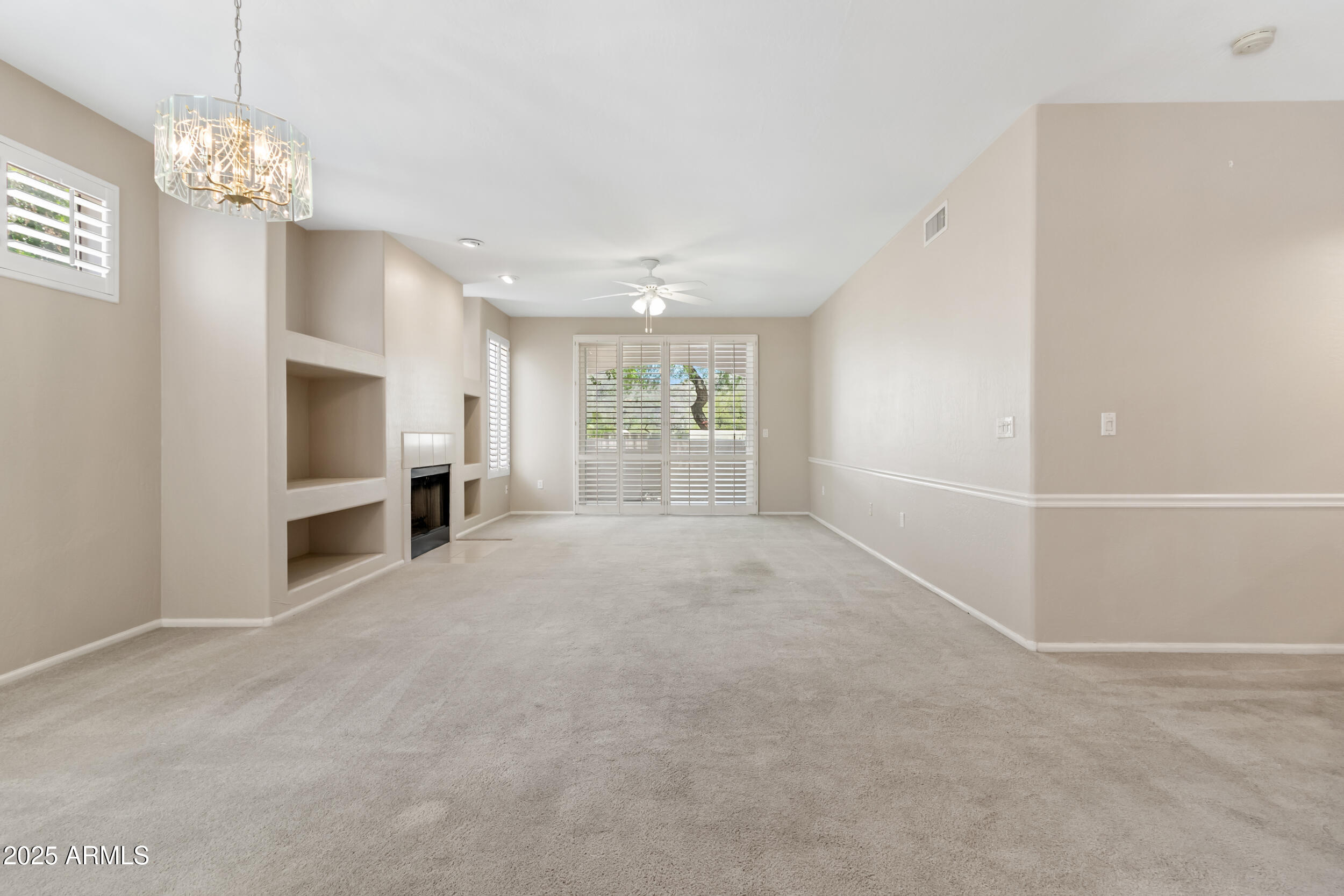 1747 East Northern Avenue, Unit 104 Phoenix, AZ 85020 - Photo 2 of 19 a view of a livingroom with a chandelier