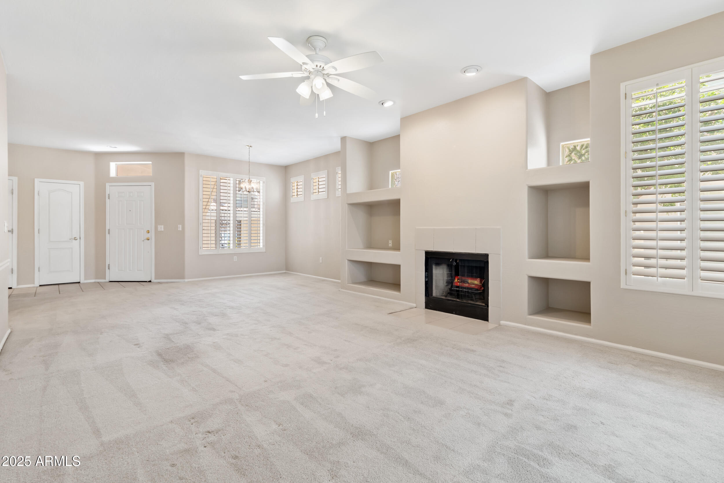 1747 East Northern Avenue, Unit 104 Phoenix, AZ 85020 - Photo 4 of 19 an empty room with windows and fireplace