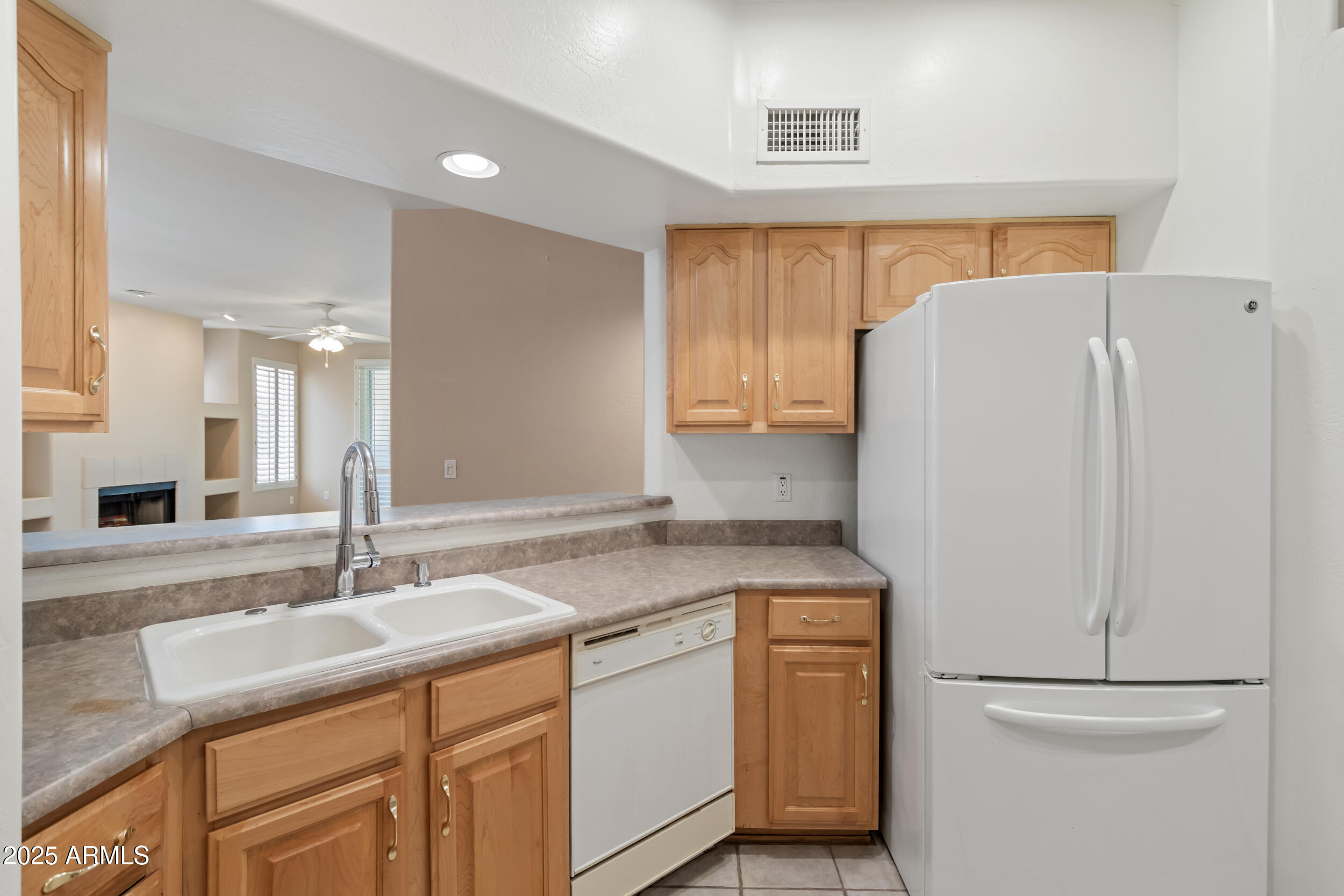 1747 East Northern Avenue, Unit 104 Phoenix, AZ 85020 - Photo 8 of 19 a kitchen with a sink and a refrigerator