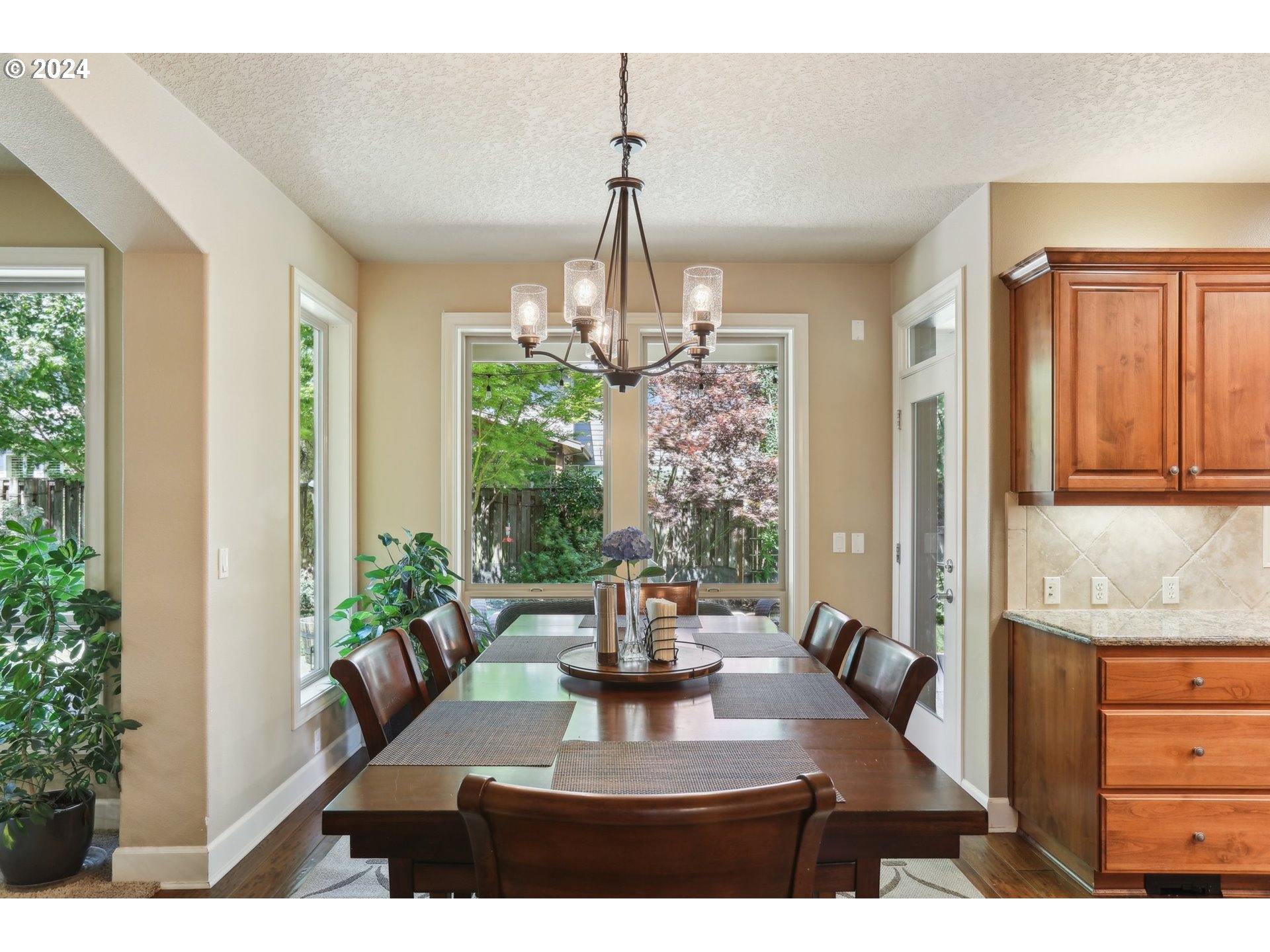 7885 Southwest Daybreak Street Wilsonville, OR 97070 - Photo 12 of 48 a view of a dining room with furniture window and wooden floor