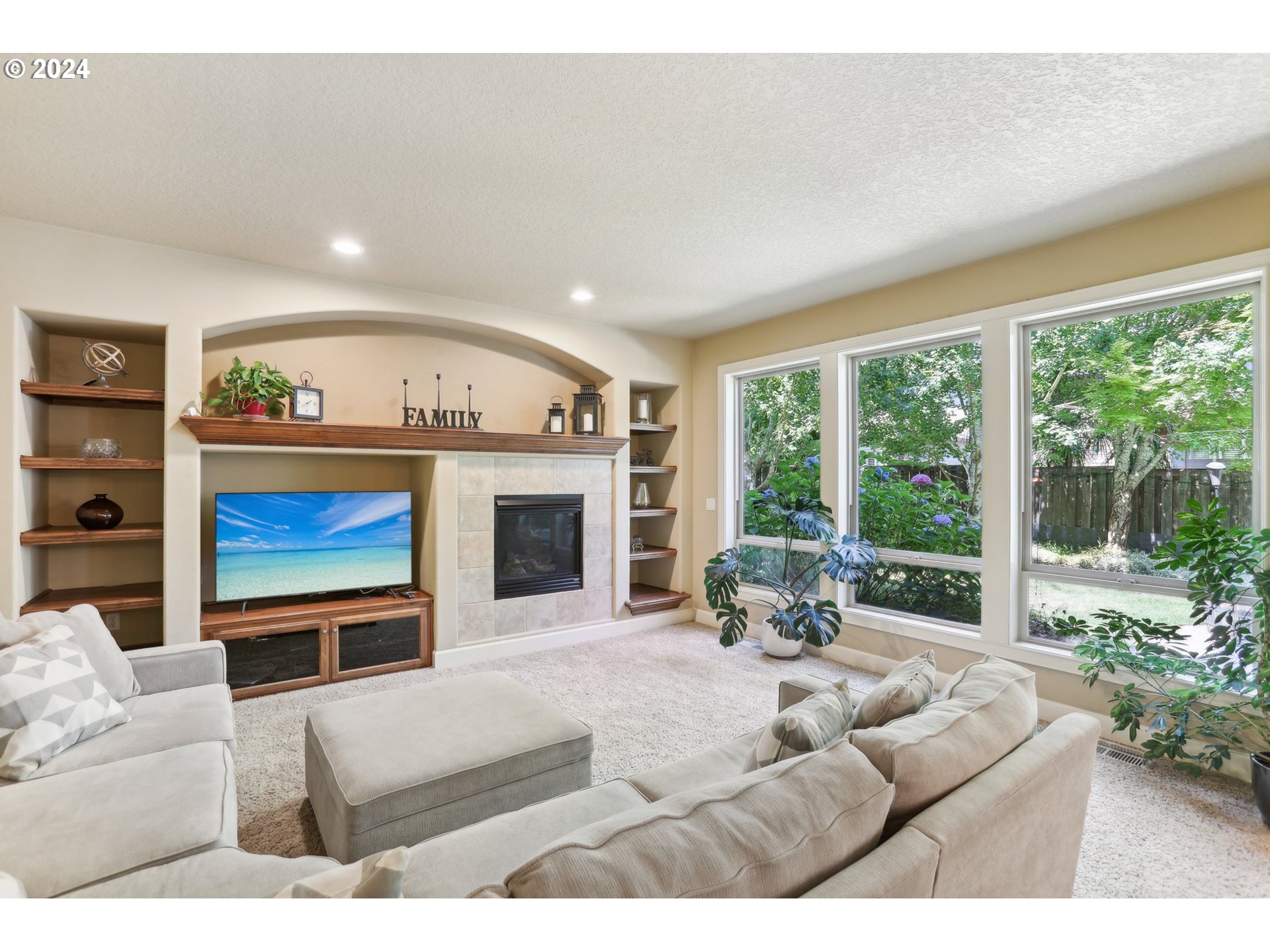 7885 Southwest Daybreak Street Wilsonville, OR 97070 - Photo 17 of 48 a living room with furniture a fireplace and a large window