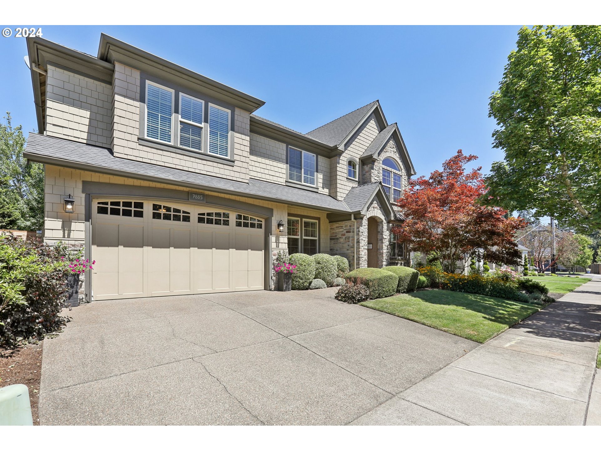 7885 Southwest Daybreak Street Wilsonville, OR 97070 - Photo 2 of 48 a front view of a house with a yard and garage