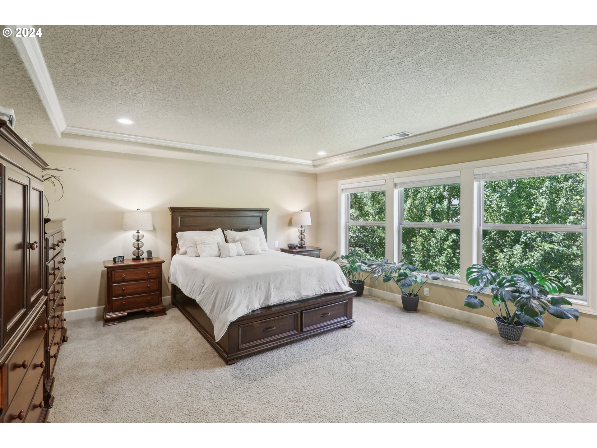 7885 Southwest Daybreak Street Wilsonville, OR 97070 - Photo 22 of 48 a spacious bedroom with a bed couch and a large window