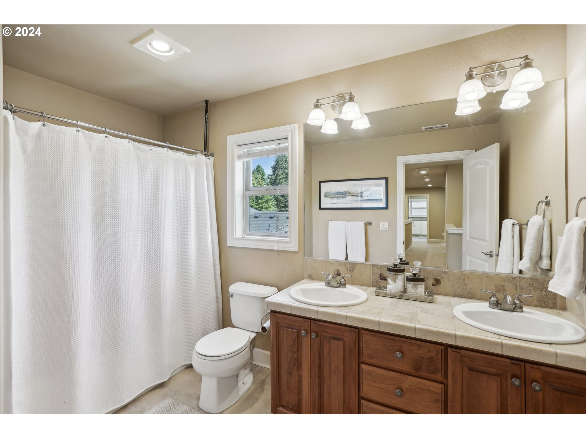7885 Southwest Daybreak Street Wilsonville, OR 97070 - Photo 29 of 48 a bathroom with a double vanity sink toilet and a mirror