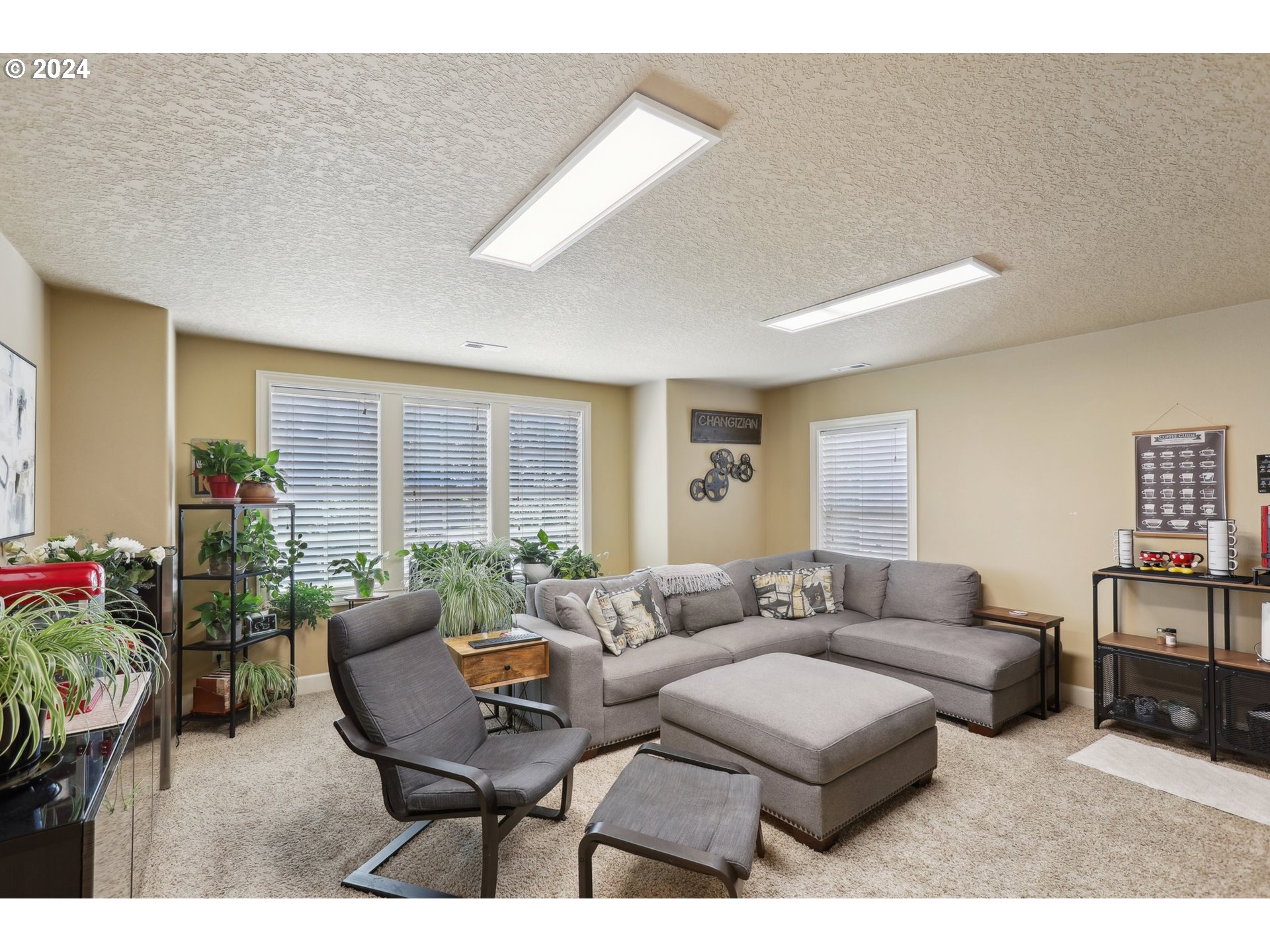 7885 Southwest Daybreak Street Wilsonville, OR 97070 - Photo 31 of 48 a living room with furniture and a potted plant
